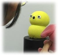 photo: Keepon looking into a person's face (eye-contact)