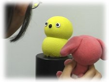 photo: Keepon looking into a person's face